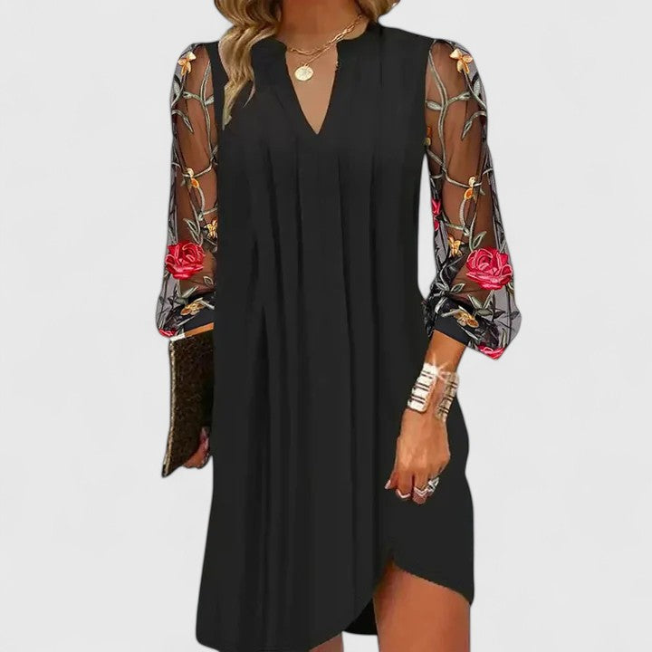Sophisticated black mini dress with long sleeves & v-neck, perfect for elegant evening parties & chic womens fashion.