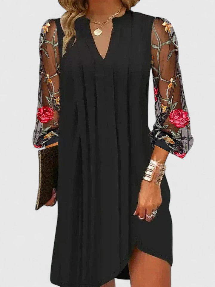 Women's elegant long sleeve v-neck mini dress. Chic black party dress for sophisticated evening wear.
