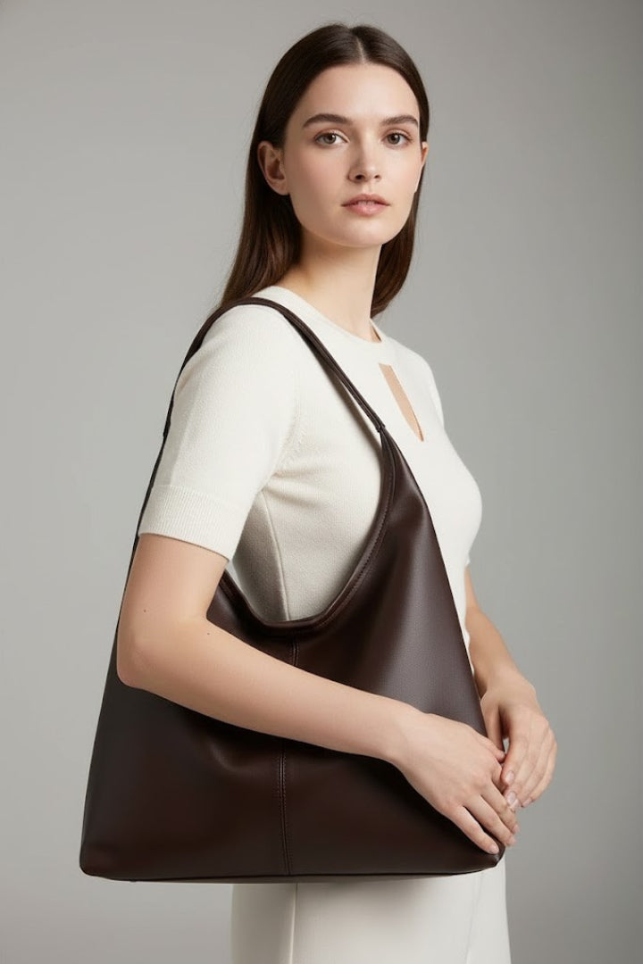 Elegant white women's handbag with a spacious interior, a versatile fashion accessory.