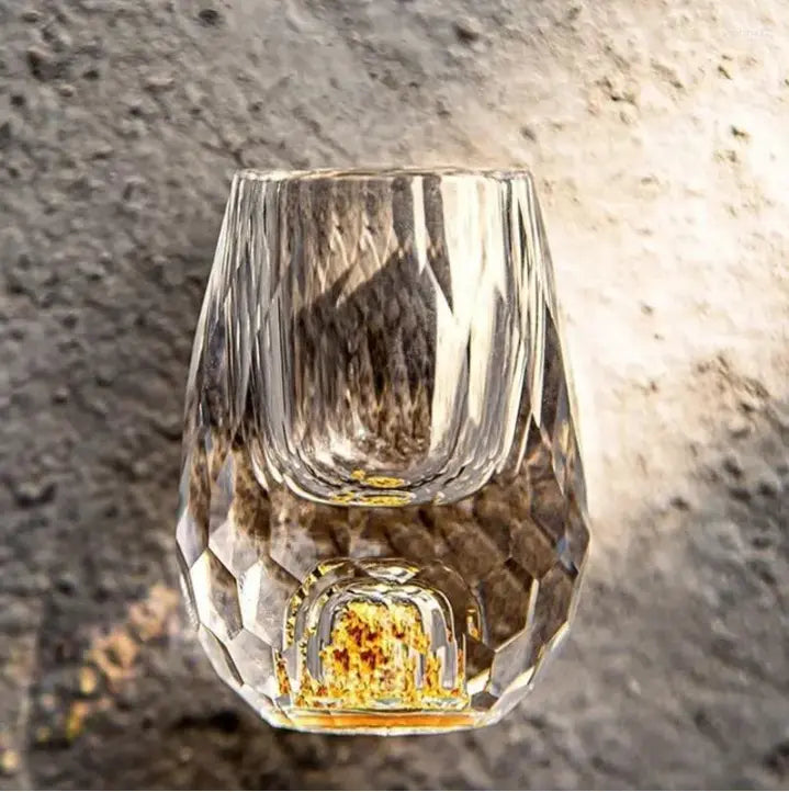 Close-up of elegant cut crystal shot glasses with sparkling facets, ideal for modern barware & celebrations.