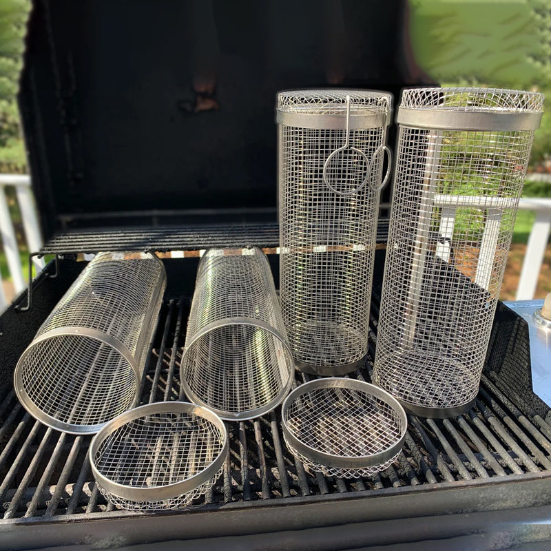 Empty stainless steel grill basket, ready for use on an outdoor barbecue. BBQ accessory.