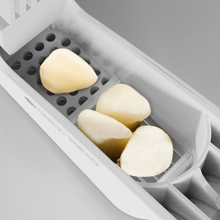 Easy-to-clean stainless steel garlic press, durable kitchen cooking tool.