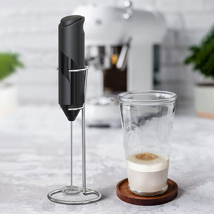 Kitchen appliance: handheld stainless steel milk frother, ready to whisk milk