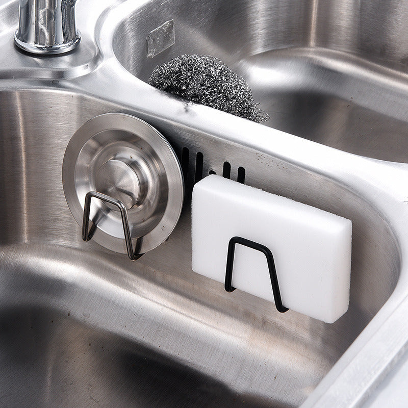 Kitchen sink area featuring a minimalist self-adhesive stainless steel sponge and brush holder
