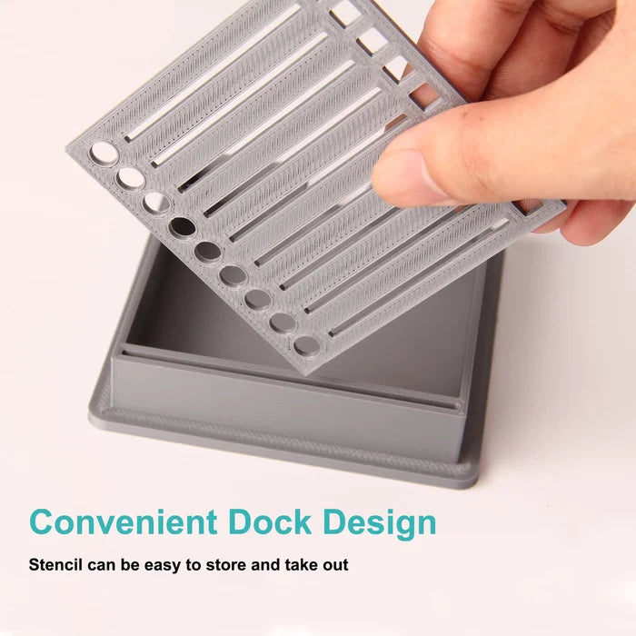 Close-up of a sticky note dispenser with a detailed stencil template, enhancing desk utility.