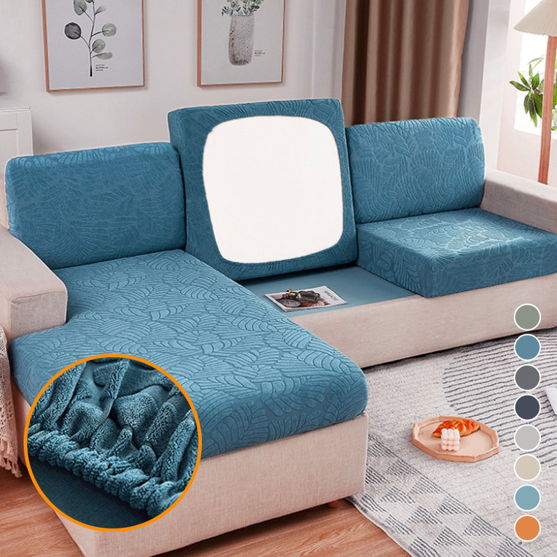 Stretchable polyester sofa cover in a neutral color, protecting a living room couch from wear and pets.