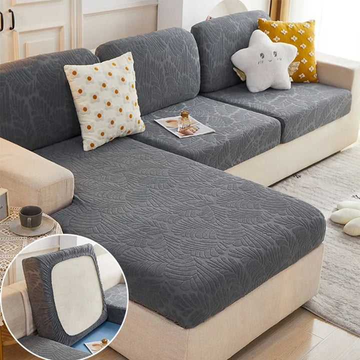 A comfortable brown sofa enhanced with a durable, pet-friendly universal stretch couch cover, adding warmth.