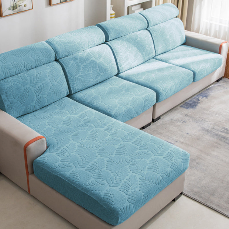 Lifestyle image of kids and a pet enjoying a sofa protected by a hard-wearing, stretchable sofa cover.