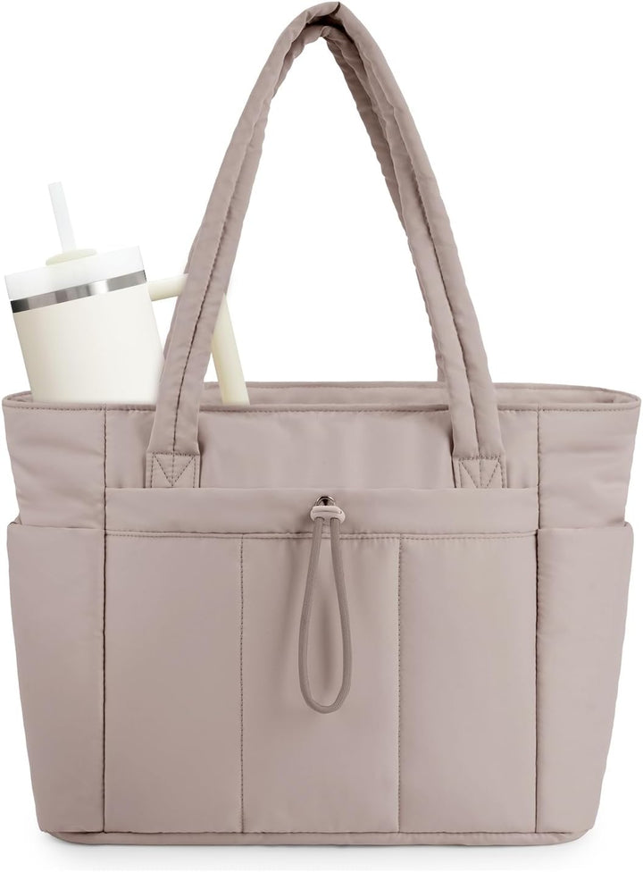 Women's beige quilted travel bag, featuring a cup holder & luggage sleeve detail.
