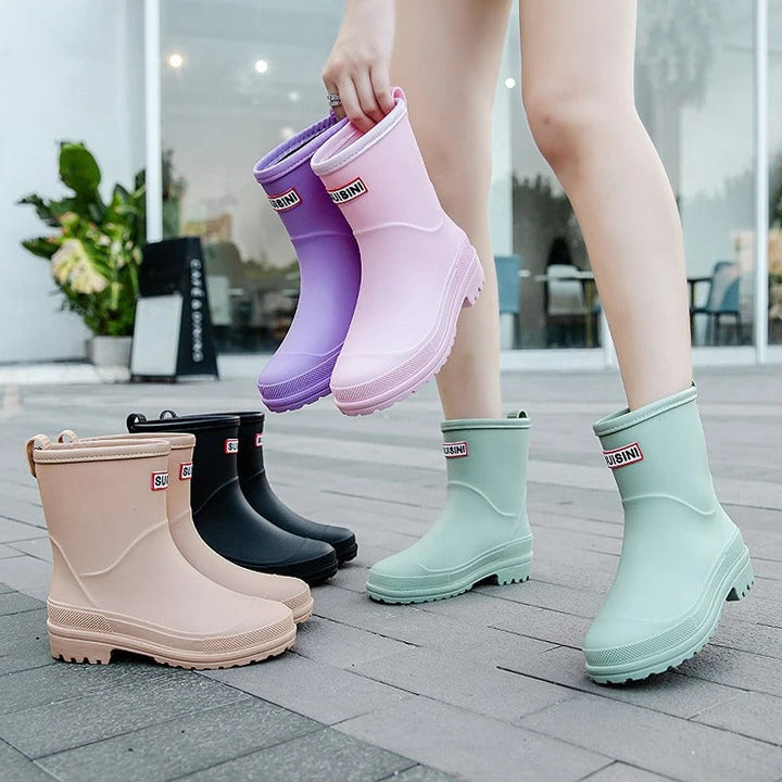 Slip-on beige women's rain boots, waterproof ankle style for comfort & dryness in any weather.