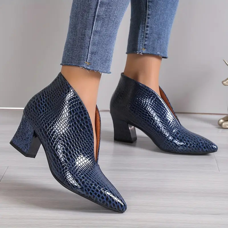 Close-up of reptile-textured women's ankle boots, highlighting the unique pattern and fashionable design.