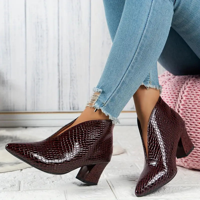 Pair of comfortable women's ankle boots, featuring a chic reptile texture for stylish footwear.