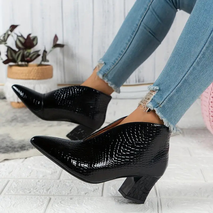 Women's stylish ankle boots with a sophisticated reptile pattern, ideal for dressy or casual looks.