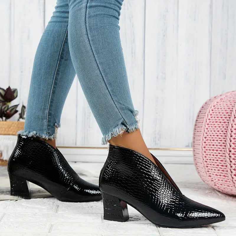 Full view of women's reptile-textured ankle boots, a comfortable and fashionable addition to winter attire.