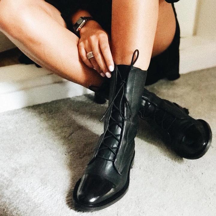 Women's versatile black leather ankle boots, featuring a comfortable low heel and durable construction.