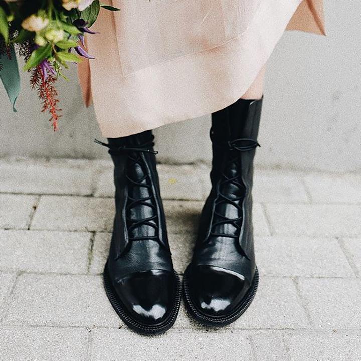 Fashionable women's ankle boots with decorative gold-tone eyelets and soft leather lining for comfort.