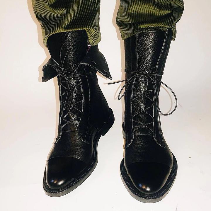 High-angle view of a women's leather ankle boot, emphasizing the sleek silhouette and timeless appeal.