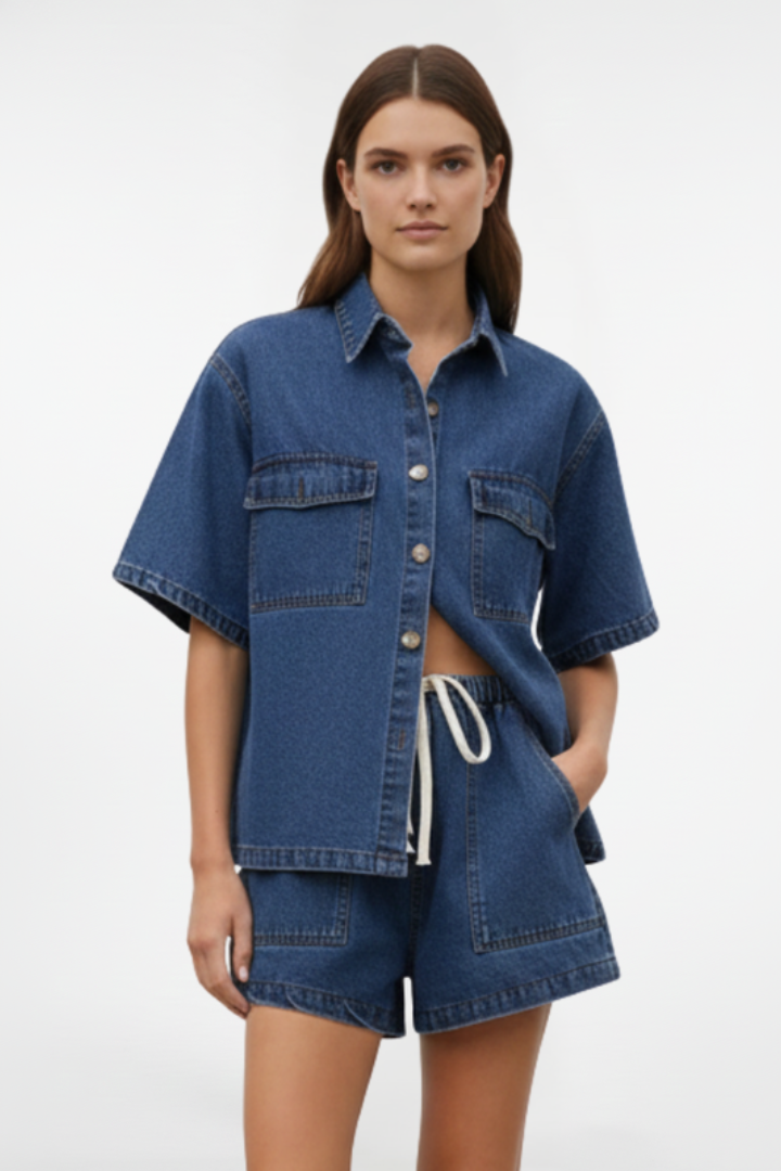 Modern women's coordinated denim short set with a stylish shirt jacket and high-waist shorts for warm weather.