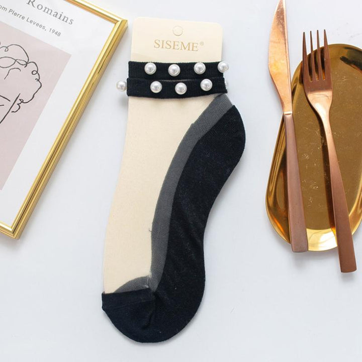 Stylish women's ankle socks with fishnet design and lustrous pearl accents.