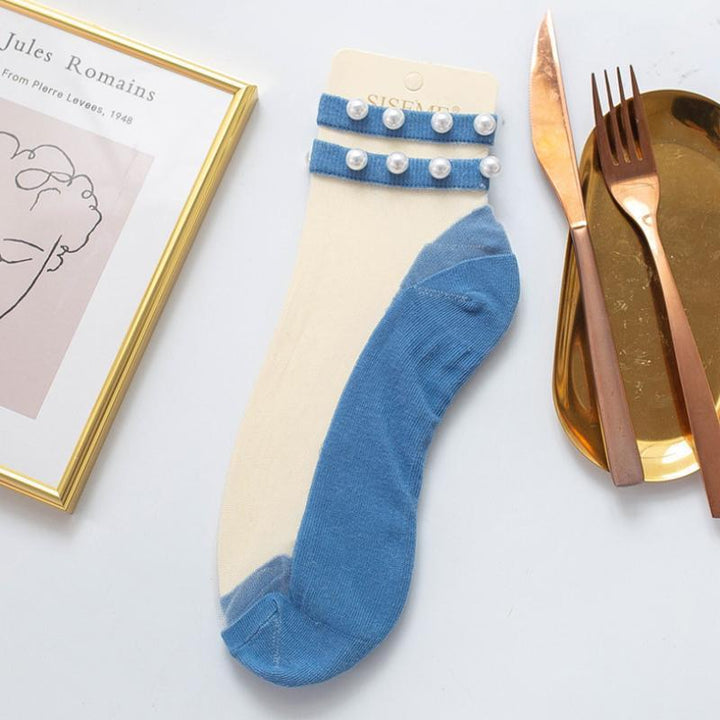 Fashionable women's fishnet ankle socks, elevated with delicate pearl elements.