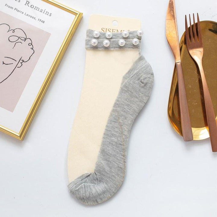 Breathable and stylish women's pearl fishnet ankle socks, perfect for warm weather.