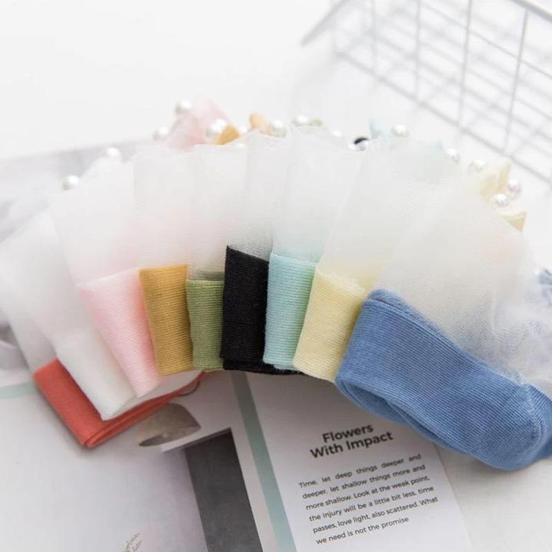 Close-up of pearl details on women's fishnet ankle socks, elegant and modern.