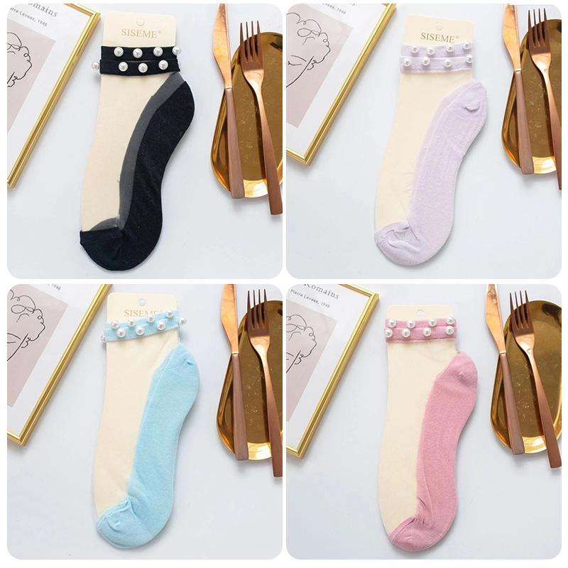 Fashion-forward women's fishnet ankle socks with delicate pearl embellishments.