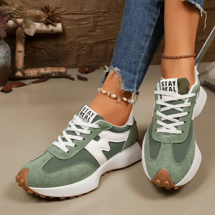 Trendy women's platform athletic sneakers with a sleek lace-up design for comfort.