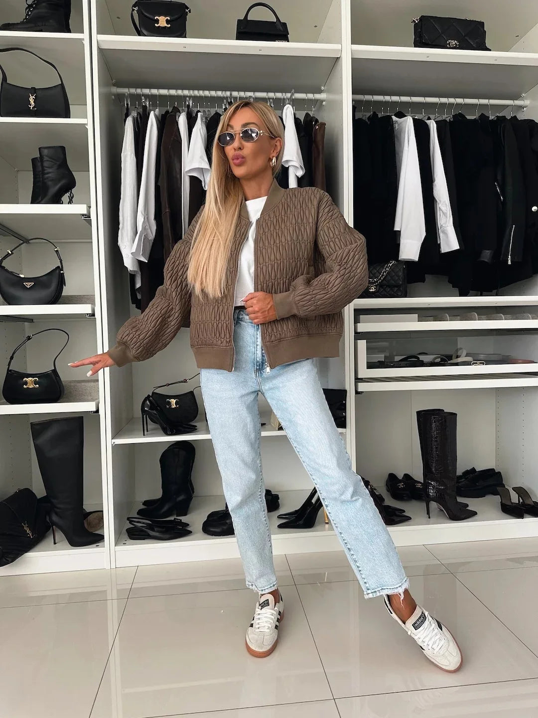 Detail of the zipper and collar on a women's quilted bomber jacket