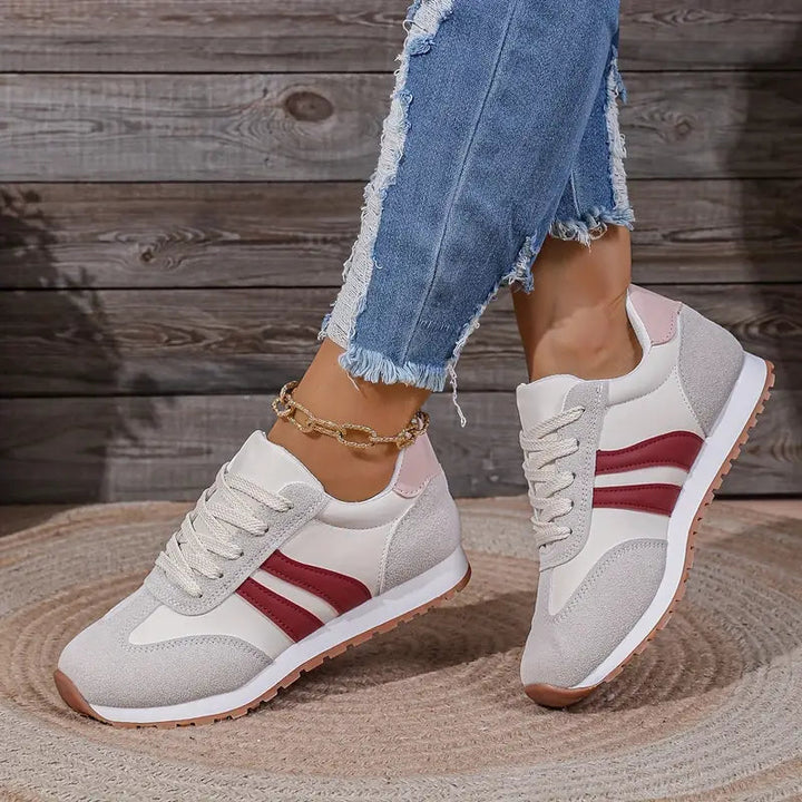 Comfortable women's fashion sneakers with a retro lace-up design. Stylish casual low-top shoes for everyday wear.