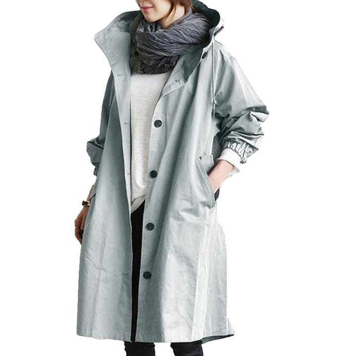 Women's waterproof long rain jacket, a stylish trench coat for effective all-weather outdoor protection.