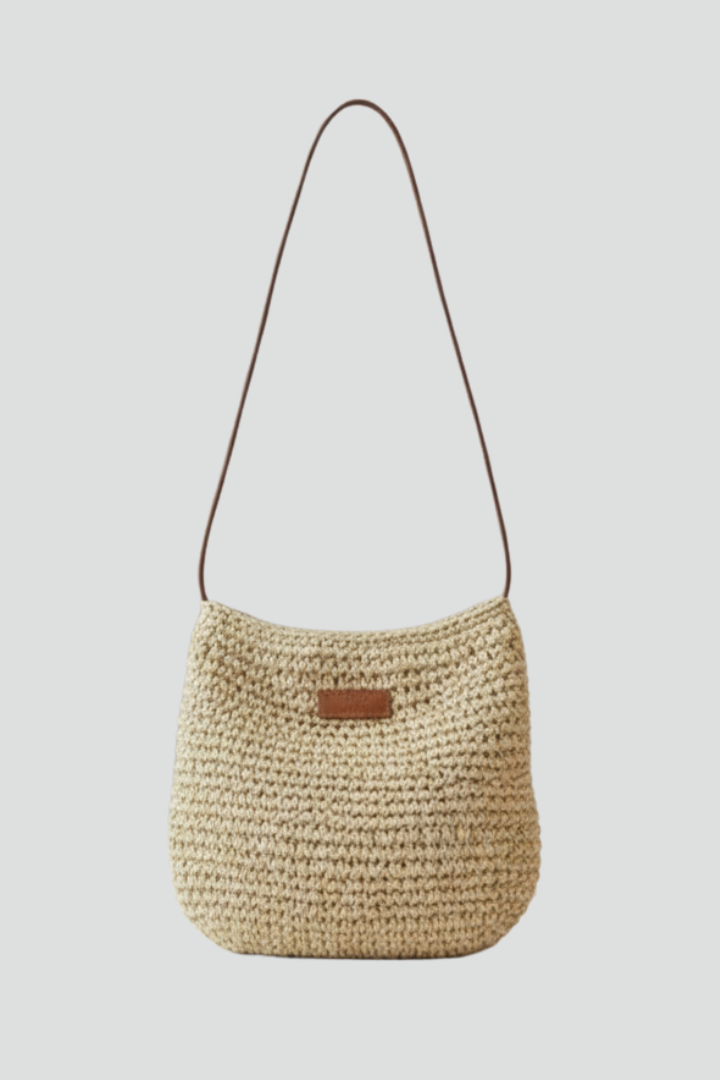 Stylish women's woven shoulder bag with long adjustable strap, perfect for everyday use. Available in beige or brown.