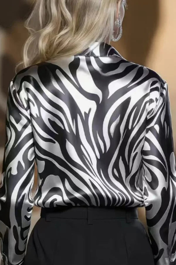 Elegant women's zebra print button-down shirt, a fashionable addition to your professional office or evening wardrobe.
