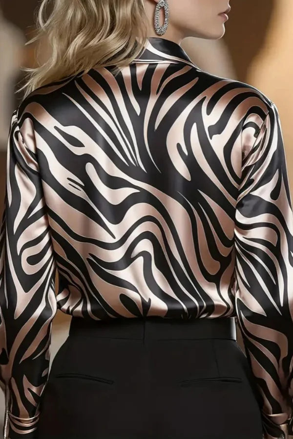Trendy women's zebra print long sleeve button-down blouse, perfect for a modern corporate look or evening occasions.