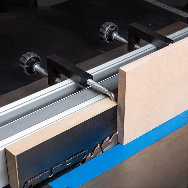 Close-up of a woodworking hold down clamp on a T-track, showing strong grip for carpentry.