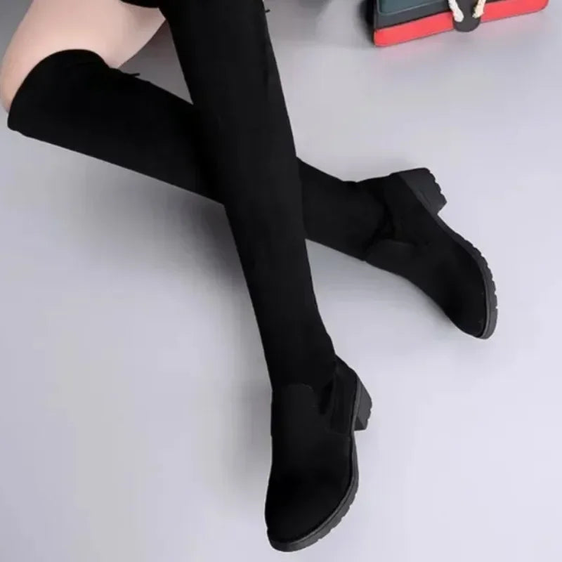 Pair of elegant women's black thigh-high boots with block heels, ideal for cold weather