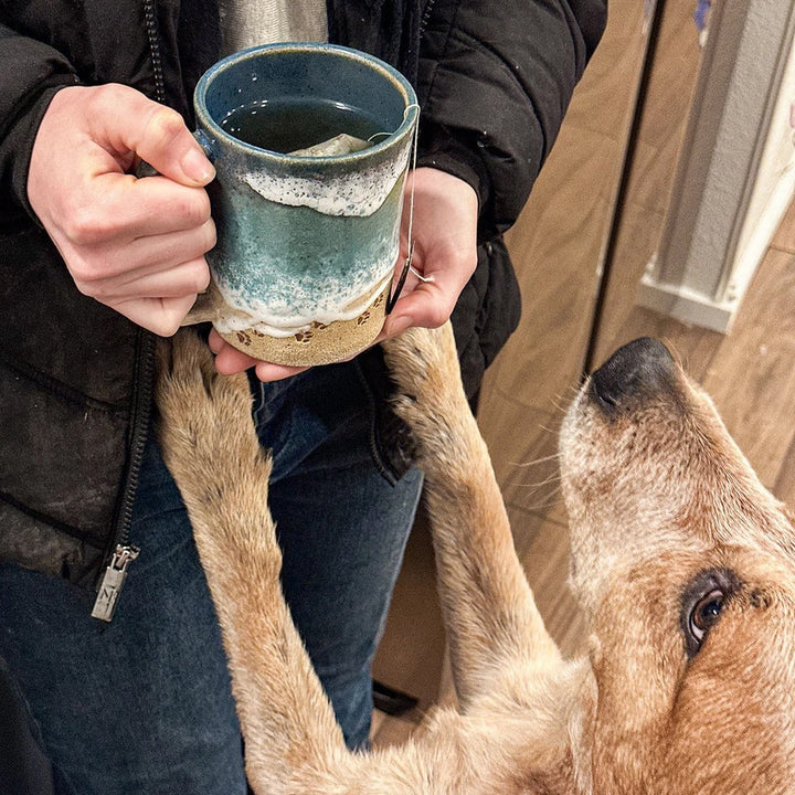 Close-up of a unique ocean paw print coffee mug, showcasing the textured ceramic finish, perfect for gifts