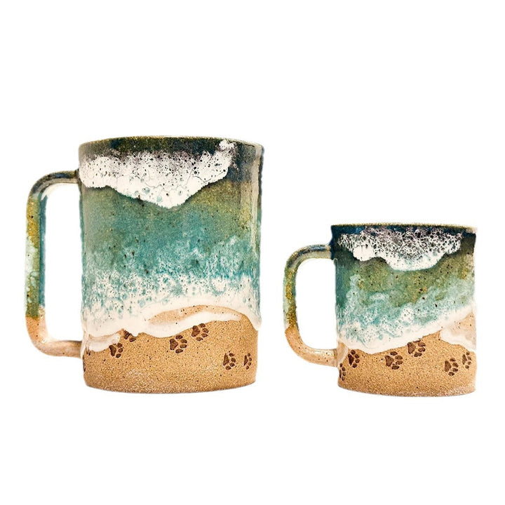 Stylish beach-themed coffee mug with a textured ocean blue glaze and charming paw print, gift idea