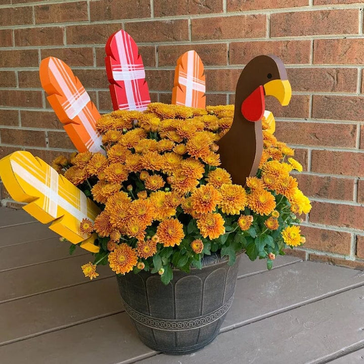 Close-up of a decorative Thanksgiving turkey planter stake, perfect fall garden gift