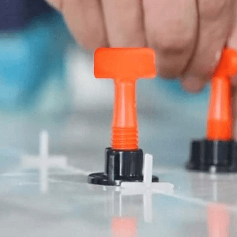 Adjustable tile leveling tools with durable spacers for precise grout lines in professional tile installation.