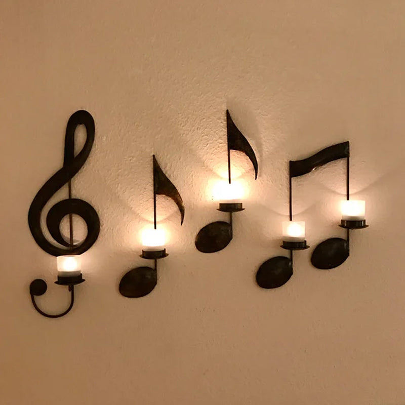 Close-up of a music note metal wall decoration, featuring a round candle holder