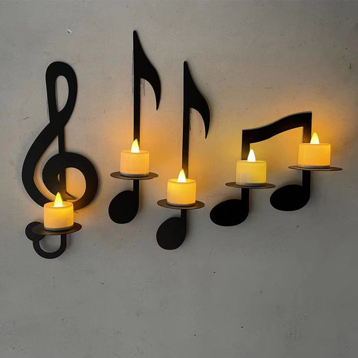 Handcrafted metal music note wall art functioning as a unique candle holder, unisex style