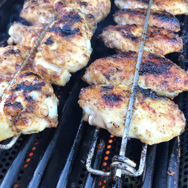 Close-up of U-shaped metal BBQ skewer, perfect for evenly cooking chicken wings & sausages on a grill