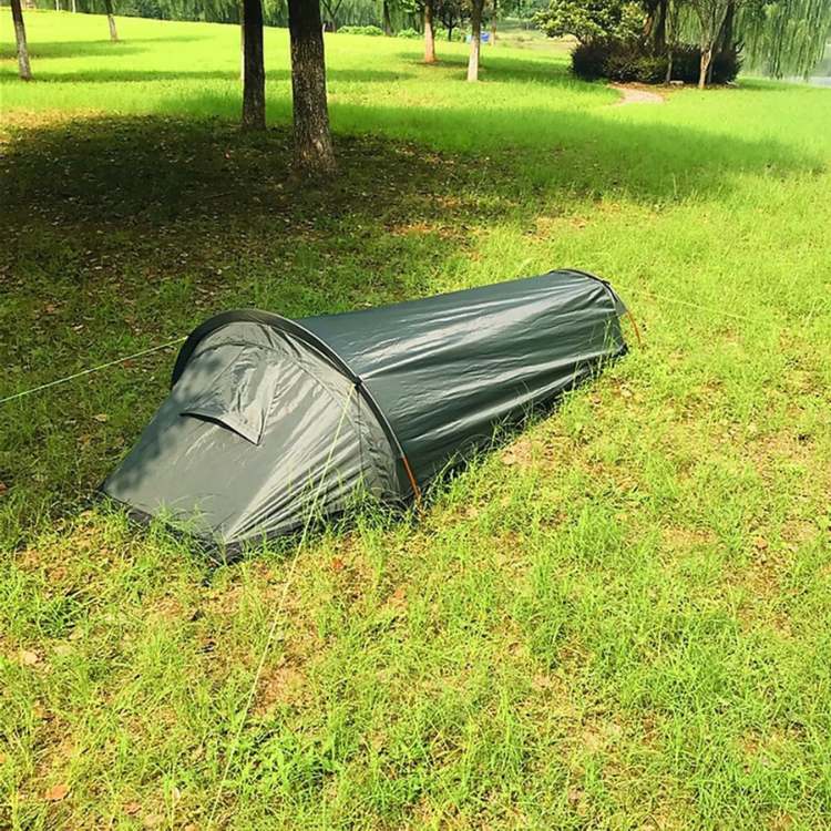 Ultralight solo camping tent in its compression sack, showcasing its compact size for backpacking gear.