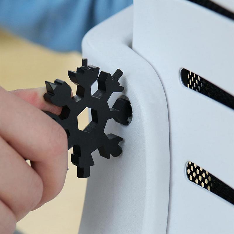 Detailed shot of the snowflake multi-tool's bottle opener function, durable stainless steel design