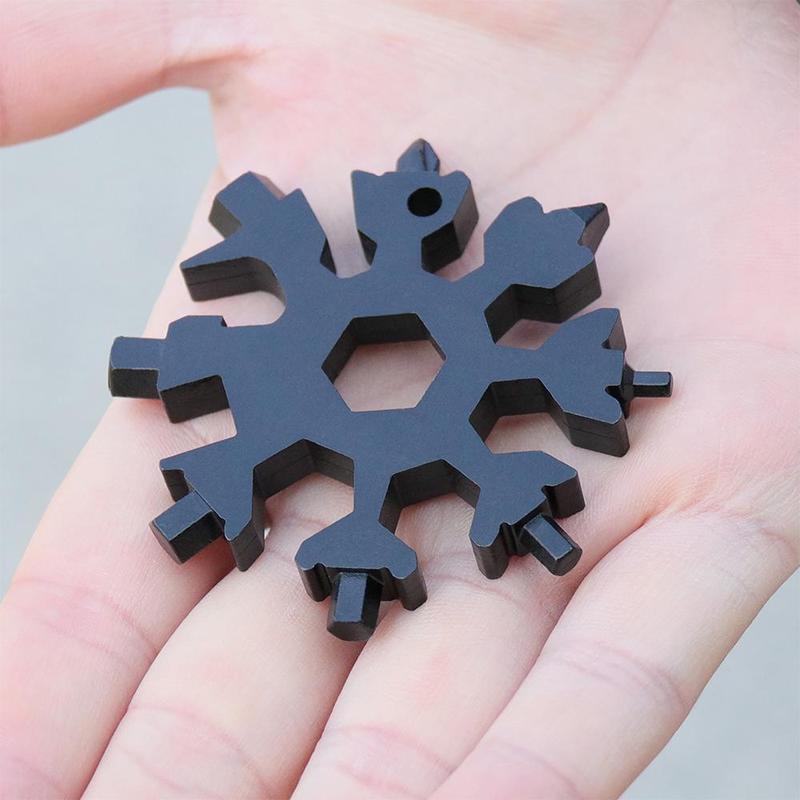 Close-up of snowflake multi-tool keychain, showing hex wrenches and screwdriver tips, portable gadget
