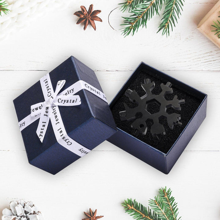 Portable snowflake multi-tool, showcasing its various tools against a plain background, stainless steel