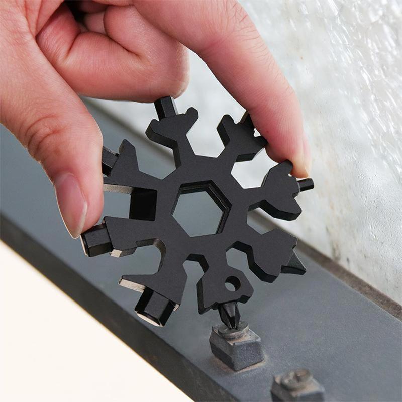 Detail view of the intricate design of the snowflake multi-tool keychain, 18 functions, silver