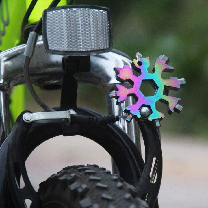 Snowflake multi-tool being used to tighten a screw, illustrating its functionality as a portable gadget