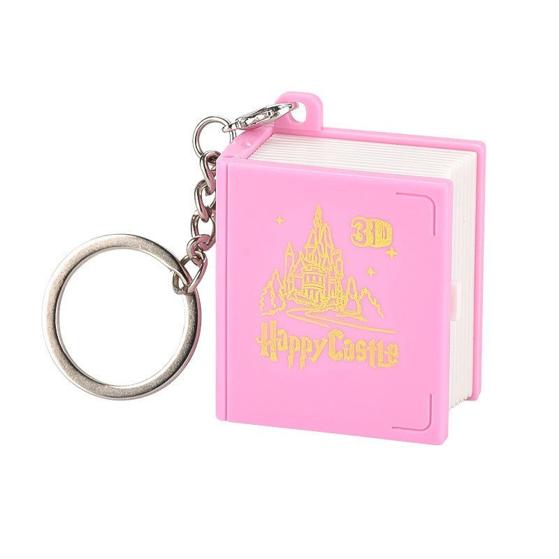 Kids hands playing with the pop-up feature of the 3D Book Keychain, a engaging fidget toy